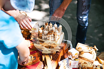 Wooden children`s toys on the nature. Boy playing dice Stock Photo