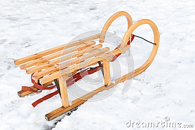 Wooden children sled in winter snow Stock Photo