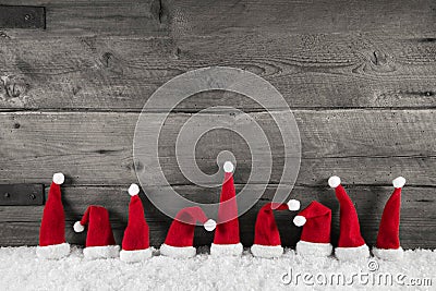 Wooden christmas background with red santa hats for a festive fr Stock Photo