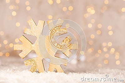 Wooden christmas decoration shaped as a snowflake with text World of Winter and soft bokeh of yellow christmaslights Stock Photo