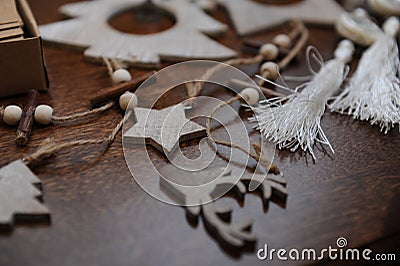 Wooden Christmas decorations handmade. Head of a deer, Christmas trees and stars. Kraft box with ribbons Stock Photo