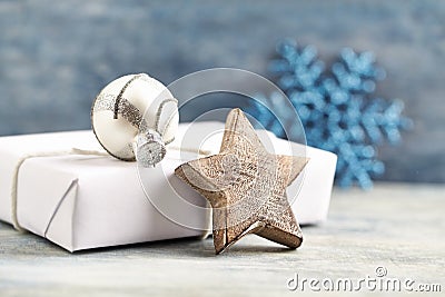 Wooden Christmas star, silver bauble and Christmas present. Christmas decoration. Stock Photo