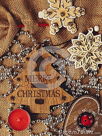 Wooden Christmas toys and candle on bag and wish: Merry Christmas Stock Photo