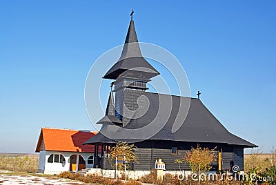 Wooden church on large field Stock Photo