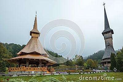 Wooden church and veranda with tall spires, Barsana, Romania Editorial Stock Photo