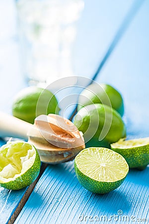 Wooden citrus squeezer and green lime Stock Photo