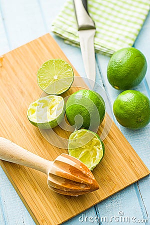 Wooden citrus squeezer and green lime Stock Photo