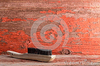 Wooden cleaning brush against old painted wall Stock Photo