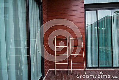 Wooden cloth rack against a wooden wall. Stock Photo