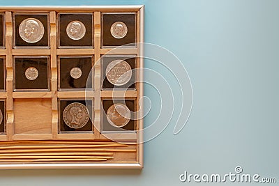 Wooden coin album display collection with encapsulated coins, numismatologist hobby with copy space. Stock Photo