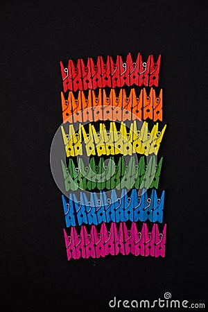 Wooden colored pegs in form of LGBT flag Stock Photo