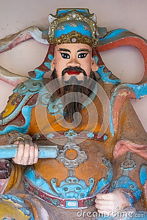 Wooden colourful guard statue at the entrance of the Linh Mu Pagoda, Hue Stock Photo