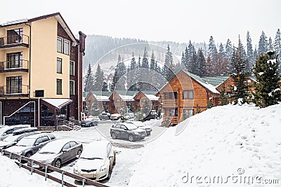 Wooden cottage house in mountain resort. Christmas winter landscape. Beautiful winter cottage covered snow. Stock Photo