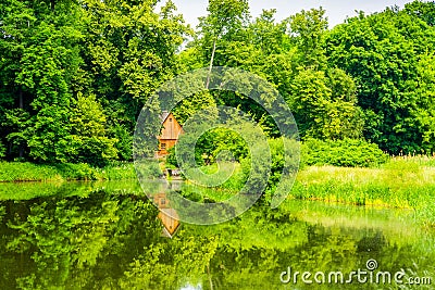 Wooden cottage house over the lake in forest Stock Photo