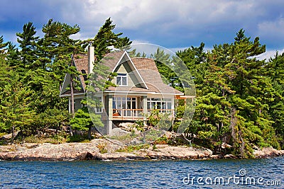 Wooden cottage on the lake Stock Photo