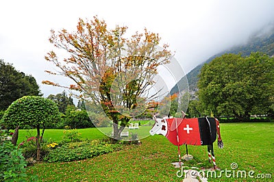 Wooden cow with red Swiss ensign in Interlaken Stock Photo