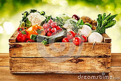 Wooden crate of farm fresh vegetables Stock Photo