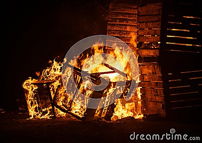 Wooden Crates on fire at night Stock Photo