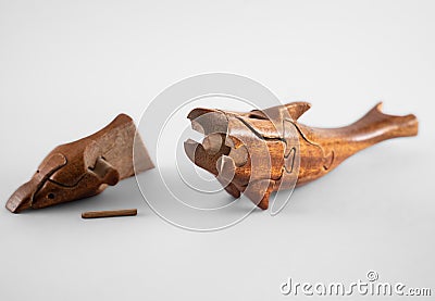 Wooden creative dolphin puzzle toy on white Stock Photo
