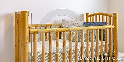 Wooden crib with mattress pillows and stuffed toy Stock Photo