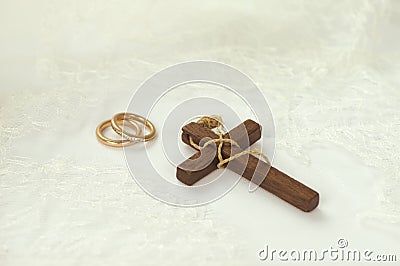 Wooden cross with golden rings Stock Photo