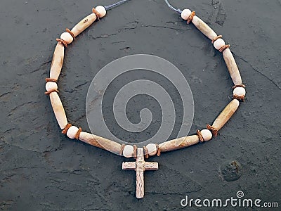 Wooden cross with a Native American designed rope for the neck. Stock Photo