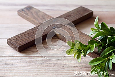 Wooden cross with sprigs of boxwood, easter symbol of life and immortality, concept Stock Photo
