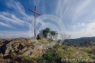 Wooden cross on the stone hill Stock Photo