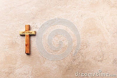 Wooden cross with text He is risen on marble background. Reminder of Jesus sacrifice and Christ resurrection. Easter Stock Photo