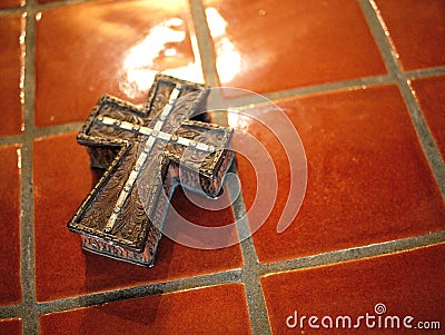 Cross on tile counter top in church. Stock Photo