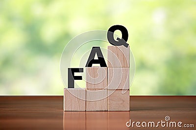 Wooden cube block shapes as step stairs with FAQ . Help concept, frequently asked Stock Photo