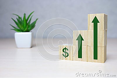 Wooden cube stack as a graph with arrows pointing up on white background. Concept of growth and success or rising successful Stock Photo