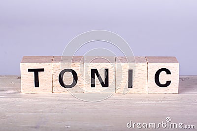 wooden cubes building the word Tonic, white background Stock Photo