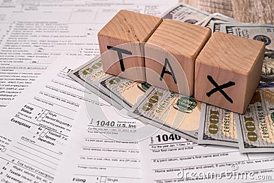 Wooden cubes with dollar banknotes on 1040 tax form Editorial Stock Photo