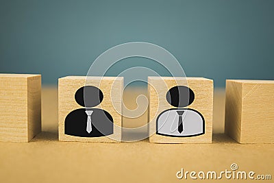 wooden cubes in the form of bosses and subordinates, personnel subordination on a blue background Stock Photo