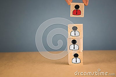 wooden cubes in the form of bosses and subordinates, personnel subordination on a blue background Stock Photo