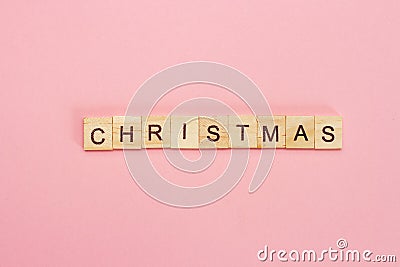 Wooden cubes inscription Christmas on pink background Stock Photo