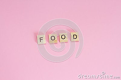 Wooden cubes inscription FOOD on pink background Stock Photo