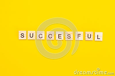Wooden cubes inscription successful words on yellow background Stock Photo