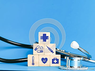 Wooden cubes with medical icons and stethescope. Concept of health care and medicine. Stock Photo