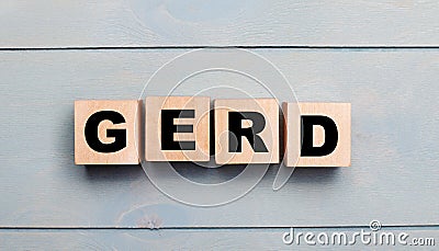 Wooden cubes with the text GERD on a light blue wooden background Stock Photo