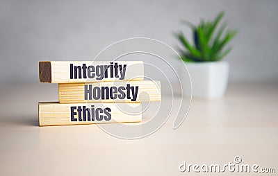 wooden cubes with text INTEGRITY, HONESTY, ETHICS. Diagram and white background Stock Photo