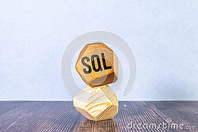 wooden cubes with text sql - short for structured query language. yellow background. Stock Photo