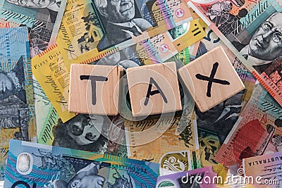 Wooden cubes with word `Tax` on australian dollars Stock Photo