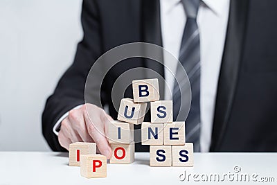 Wooden cubes with words business and IPO, business IPO concept, businesman in suit Stock Photo