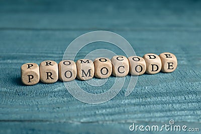 Wooden cubes with words Promo Code on blue table Stock Photo