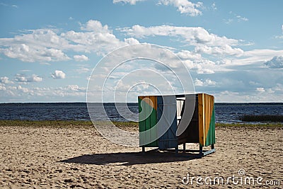 Wooden cubicle changing rooms on beach Stock Photo