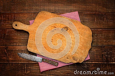 A wooden cutting board with a vintage rural knife. Background. Stock Photo