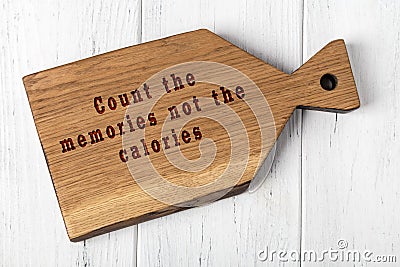 Wooden cutting board with wise inscription about food Stock Photo