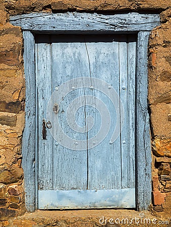 Wooden cyan window shutter in a traditional brickwork exterior wall. Stock Photo